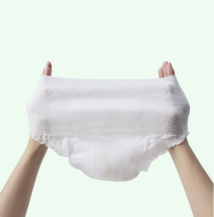 White diaper pant held up against a light gray background