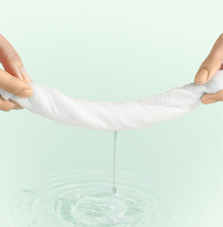 White wipe being stretched over a light green background