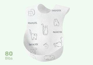White bib with black line drawings of cats and text on a light green background

