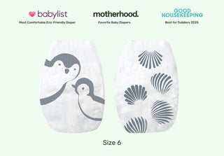 Two baby diapers with penguin design on a light green background, featuring awards from Babylist, Motherhood, and Good Housekeeping.
