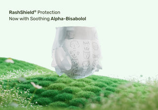 Diaper with RashShield protection on a grassy background
